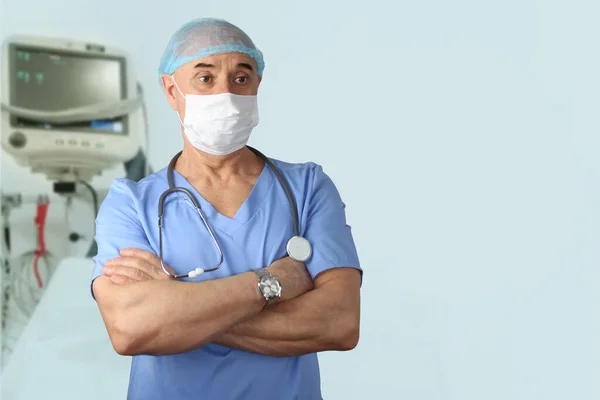 male doctor in medical mask with a stethoscope on the background of ventilation, the concept of medical care, quarantine, medical tourism