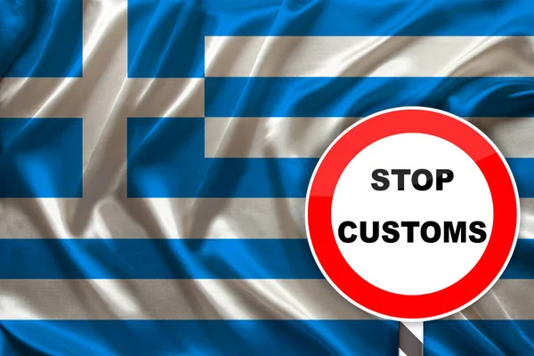 customs sign, stop, attention on the background of the silk national flag of Greece, the concept of border and customs control, violation of the state border, tourism restrictions