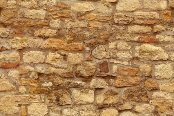 seamless horizontal texture of an old wall made of rubble stone, brown sandstone, with the remains of cracked old plaster, a blank for the designer, wallpaper