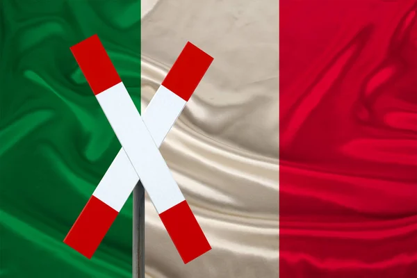 customs sign, stop, attention on the background of the silk national flag of Italy, the concept of border and customs control, violation of the state border, tourism restrictions