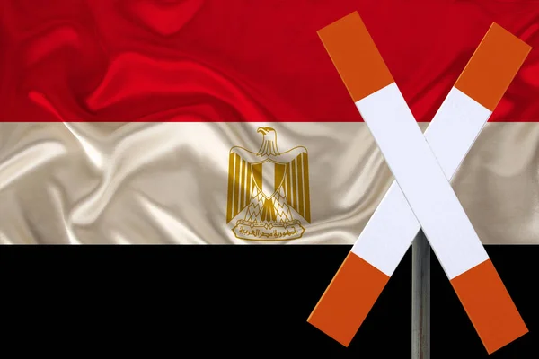 customs sign, stop, attention on the background of the silk national flag of Egypt, the concept of border and customs control, violation of the state border, tourism restrictions