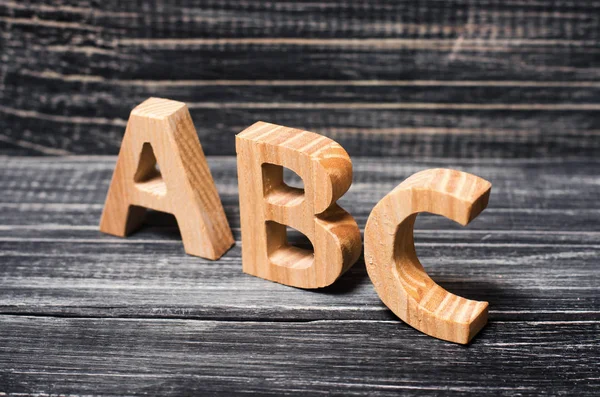 Alfabeto in legno sullo sfondo di una tavola, ebano . — Foto Stock
