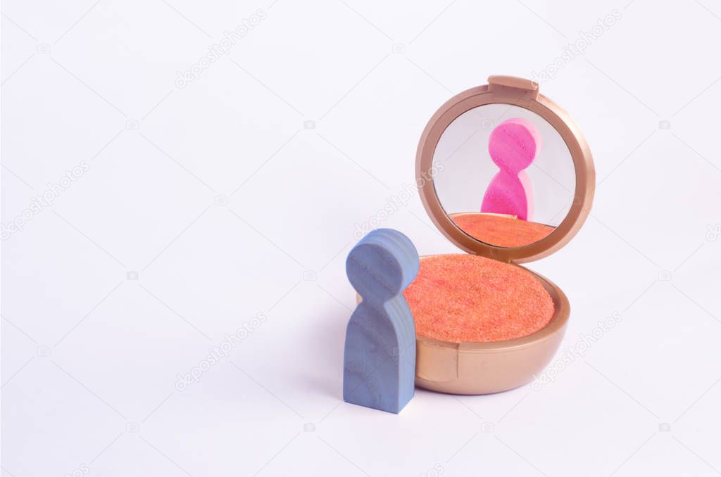A miniature figure of a man looks in the mirror and sees his hatching in another gender. The concept of gender identity. Transgender, gay lesbian person. Sex education, inequality and gender equality.