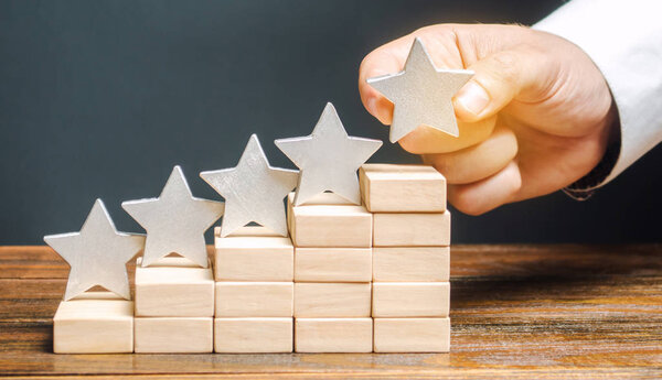 Critic puts the fifth star. The concept of the rating of hotels and restaurants. The evaluation of visitors. Quality level, good service. Best customer rating. Feedback. Satisfaction