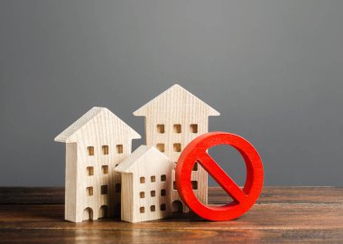 Apartment buildings and red prohibition symbol NO. Emergency and unsuitable for living building. Unavailable expensive housing. Lack of living space and the impossibility of building a new houses. clipart