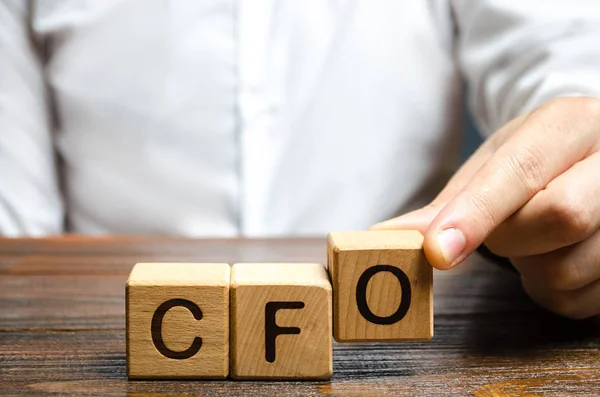 A man makes the word acronym abbreviation CFO. Chief Financial Officer. Financial management in business and company. Risk. Development and growth. Appointment to a new post, promotion. — Stock Photo, Image