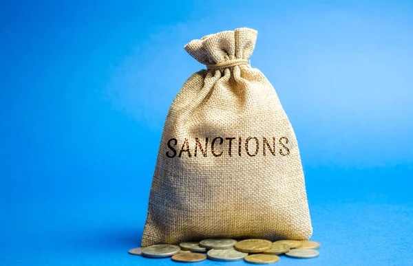 Money bag with the word Sanctions. The imposition of economic and political sanctions on the subjects of geopolitics. Restriction and pressure of the world community