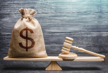 Bir dolar işareti ve terazide hakimin çekici olan bir çanta. Bir yasanın ya da normların kabulü için lobi faaliyetleri, yolsuzluk. Cezalar ve cezalar ödenecek. Hasar tazminatı