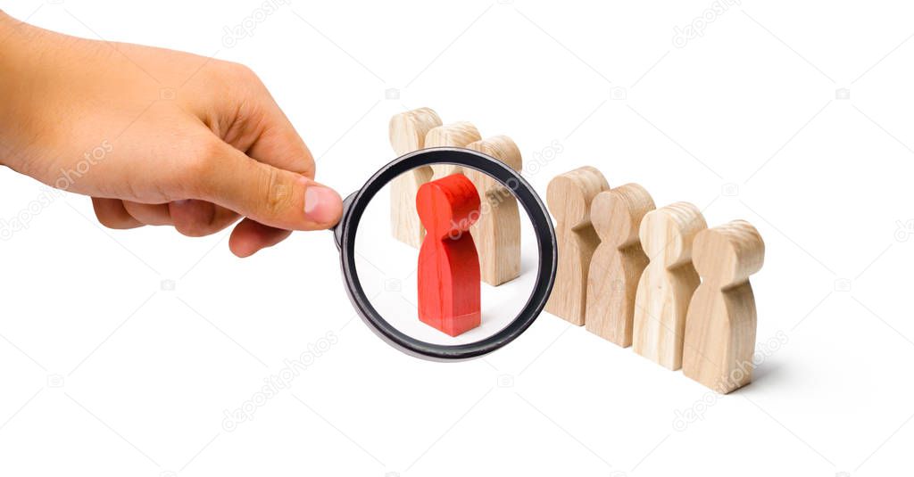 Magnifying glass is looking at the red figure of a man comes out of the line of people. Talent, leader, professional. improvement in work, the universal recognition of efficiency and leadership