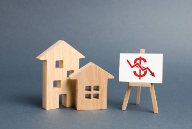 Two wooden houses and a poster with a symbol of falling value. concept of real estate value decrease. low liquidity and attractiveness of assets. cheapening the rent or cost of buying a home clipart