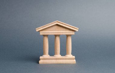 Gri arka planda ahşap bir hükümet binası. Yetkililer, ülkenin egemenliği ve hukukun üstünlüğü. Devlet idaresi ve ekonomi kurumları kavramı. Banka ya da üniversite