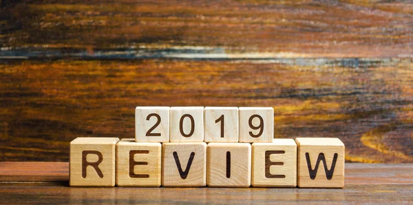 stock image Wooden blocks with the word Review 2019. Business concept. Feedback, Progress. New trends and prospects. Financial performance indicator. Results of the year. Financial and economic activities. Audit.