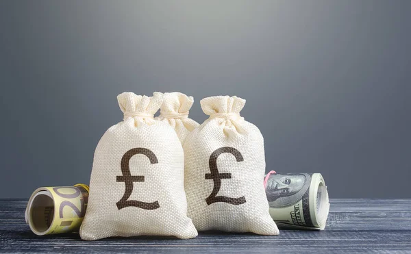 Pound sterling money bags. Capital investment, savings. Economics, lending business. Banking service, monetary policy. Reserve currency. Profit income, dividends. Crowdfunding startups investing.