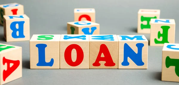 Wooden blocks with the word Loan. Consumer, banking and property loan. Business and entrepreneurial development. Small business loans. Interest rate repayment. Planning. Mortgage. Credit