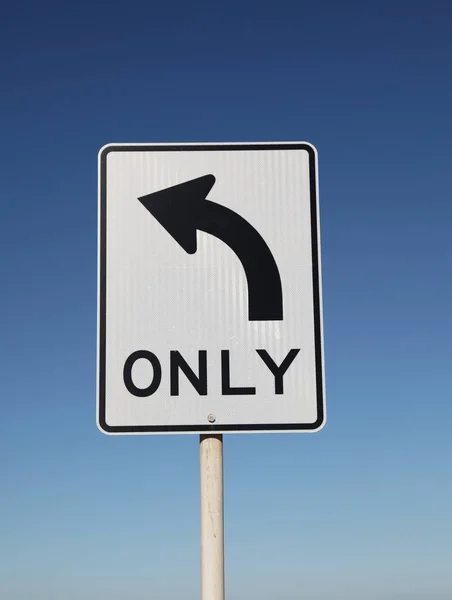 Left Turn Only Sign with blue sky background — Stock Photo, Image