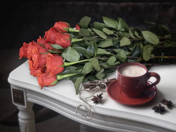 Still life with roses and coffee on a table