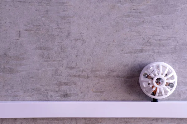 fire detector installed on a concrete wall