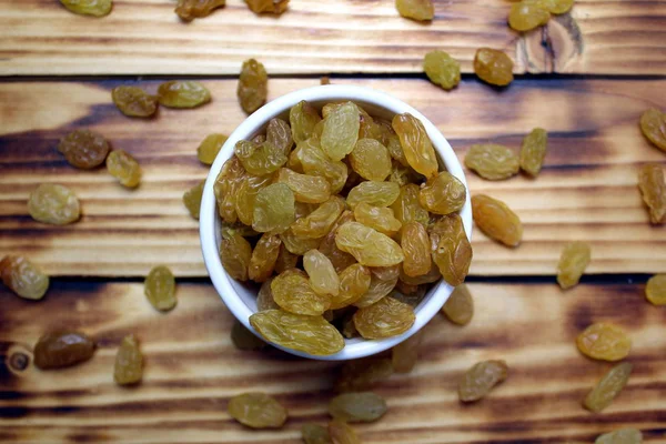 Yellow Raisins White Plate Wooden Table — Stock Photo, Image