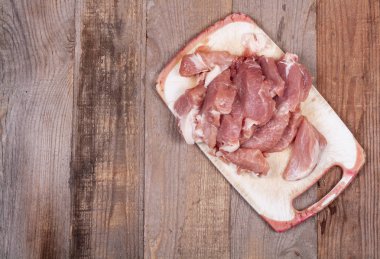 Koyu ahşap bir masada taze doğranmış et.