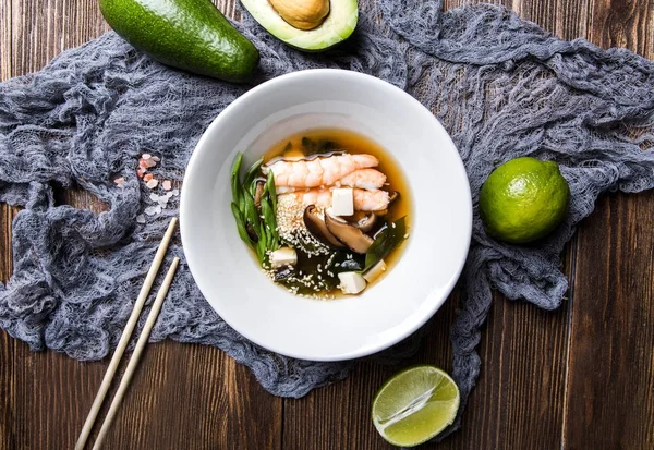 Japanese miso soup with seafood on a dark wooden background top — Stock Image Japanese miso soup with seafood on a dark wooden background top Stock Photo