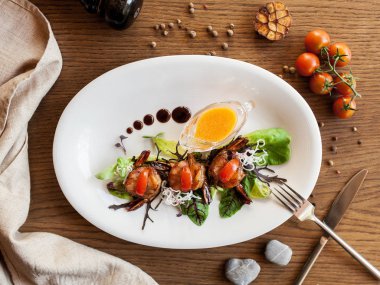 domates, portakal sosu ve marul üzerine ahşap bir masa ile ızgara karides