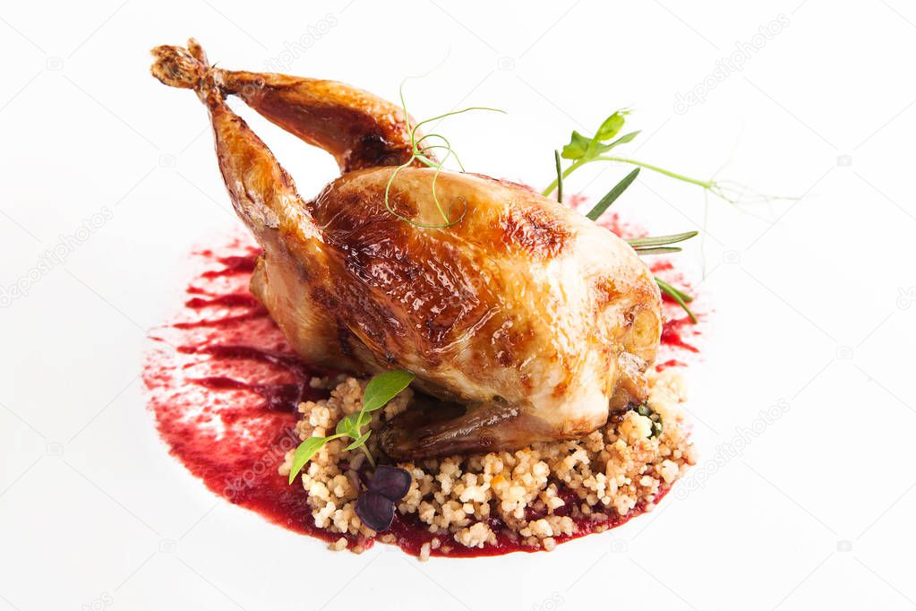 roasted quail with berry sauce and blackberries on a white background
