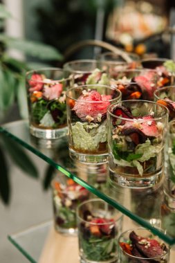 Catering food, buffet zone salad with vegetables and roastbeef in glasses