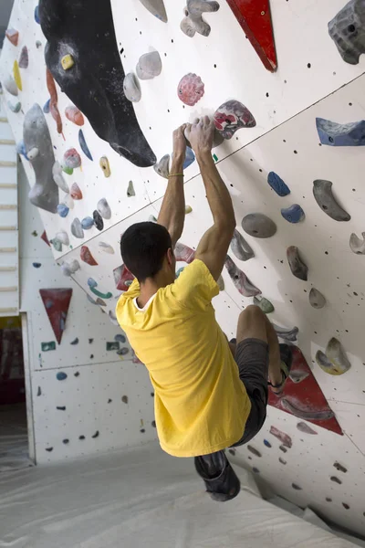 Indoor rock climbing man