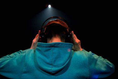 Bir gece kulübünde DJ iş. Club disko ışığı. Arkadan Görünüm. Kulaklık Dj.