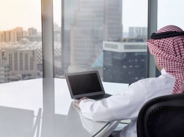 Laptop çalışma düşünürken izleyen Suudi Arap adamım