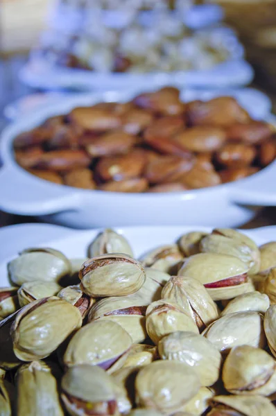Almonds, Pistachios, Cashew Mix of Nuts in Plates — Stock Photo, Image