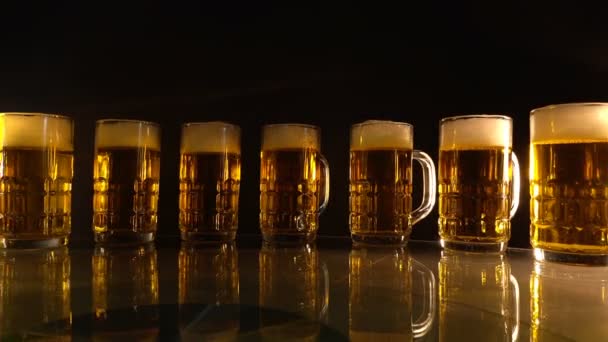 组合啤酒杯 有空气漂浮气泡 黑色背景上的金色色调 — 图库视频影像