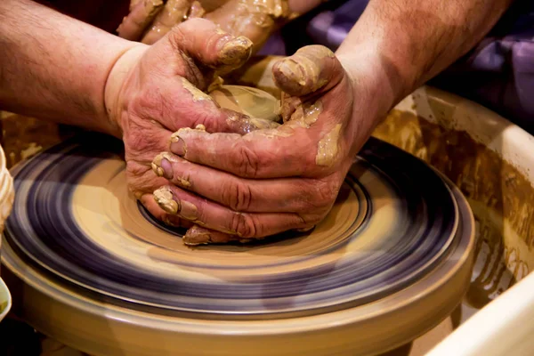 Pottery making a jar of raw clay on a potter's machine with men's hands — Stock Photo, Image