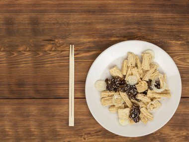 Baharatlı Çin ya da Kore Yuba tofu bambu ve ahşap arka planda istiridye mantarı..