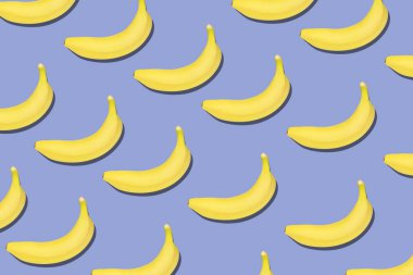 Yaz kavramı. Mavi arka planda taze sarı muzların renkli meyve desenleri. Üst görünüm