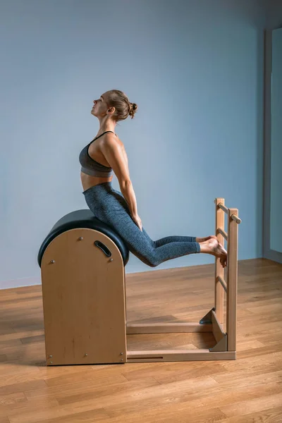 Portrait of Woman Pilates Trainer Doing Exersices on the Ladder