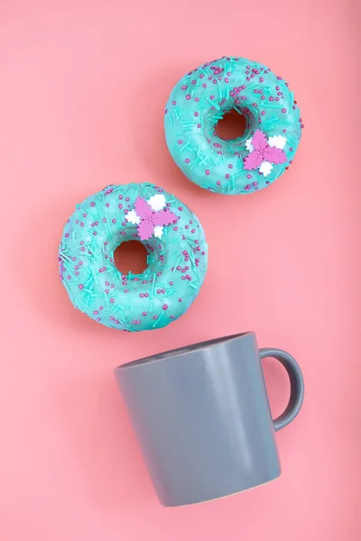 Blue Donuts with icing and coffe cup on pastel rose background. Sweet donuts. — Stock Photo, Image