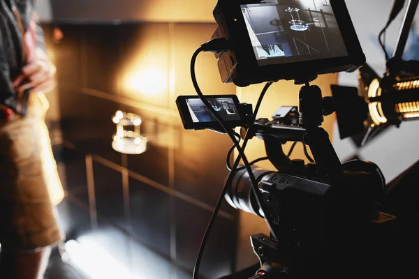 Video production backstage. Behind the scenes of creating video content, a professional team of cameramen with a director filming commercial ads. Video content creation, video creation industry. Low