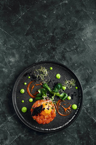 Salmon tartare with avocado and vegetables, a beautiful layout by the chef, a beautiful malohot - marble background. Food photo, advertising banner, copy space, Italian cuisine