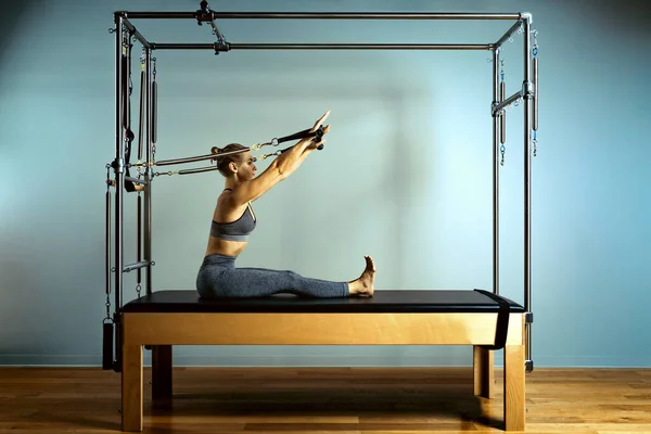 Mujer motivada activa hace ejercicios en reformador cama, belleza y salud. Plástico, postura, fitness inteligente . — Foto de Stock