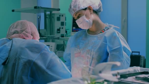 Close-up of surgeon. Doctors and assistants working in the operating room. Surgical team and honey nurse during a real operation in a modern operating room, 4k — Stock Video