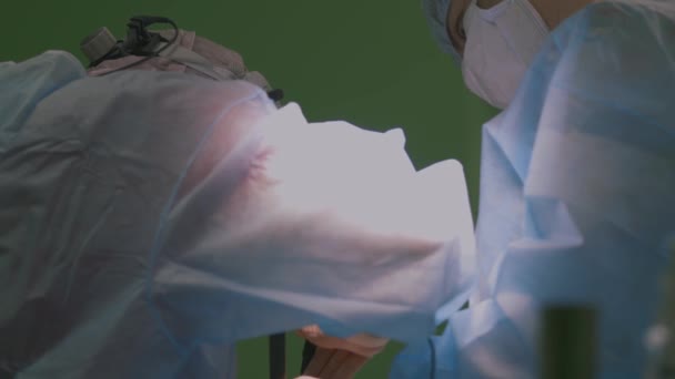 Γιατροί και βοηθοί δουλεύουν στο χειρουργείο. Χειρουργική ομάδα και νοσοκόμα μελιού κατά τη διάρκεια μιας πραγματικής επέμβασης σε ένα σύγχρονο χειρουργείο, 4k — Αρχείο Βίντεο
