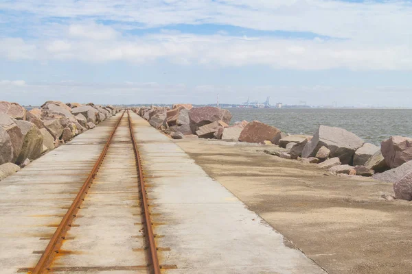 Rail over breakwater at Cassino beach — Stock Photo, Image