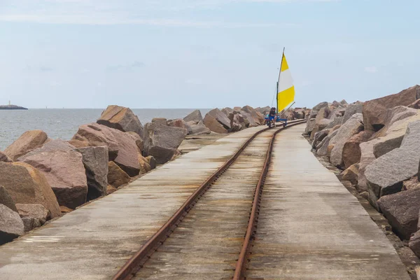 Vagoneta in the rail over breakwater at Cassino beach — Stock Photo, Image