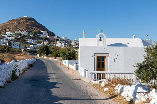 Small church with Plaka village in background, Milos, Greece