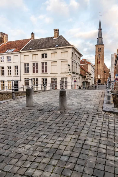 Buildings, street and church tower in Bruges, Belgium