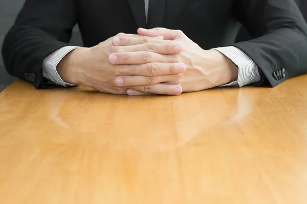 Businessman joining hands on wood table — Stock Photo, Image