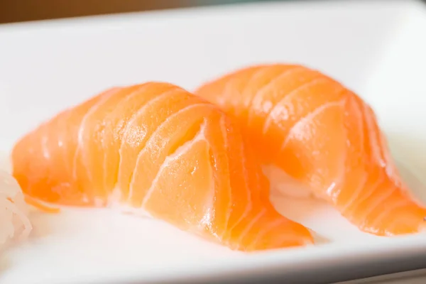 Sushi salmon on white plate — Stock Photo, Image