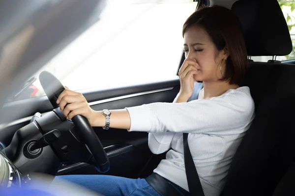 Joven asiática mujer hold su nariz debido a mal olor sucio en coche — Foto de Stock