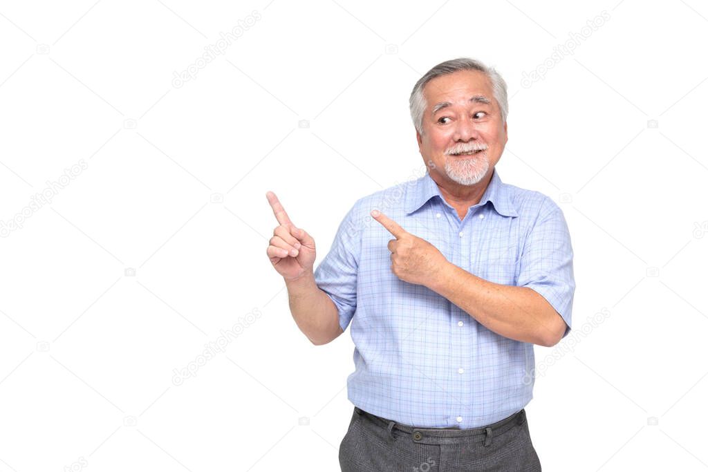 Asian senior man smiling and pointing to empty copy space isolated on white background